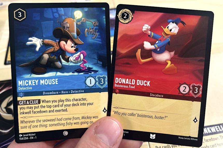 Disney Lorcana character cards:
Mickey Mouse Detective (blue)
Donald Duck Boisterous Fowl (red)