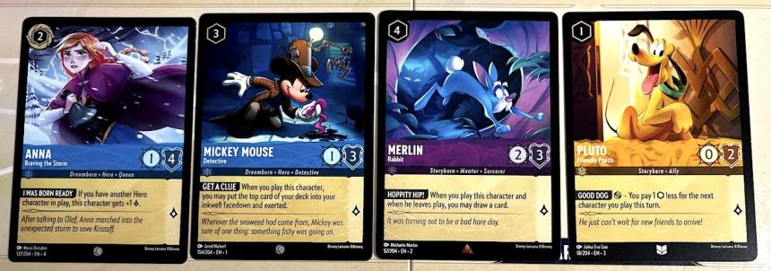 Disney Lorcana cards: Anna Braving the Storm (blue), Mickey Mouse Detective (blue), Merlin Rabbit (purple), Pluto Friendly Pooch (yellow)