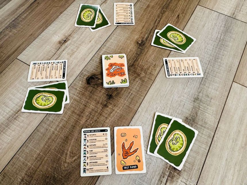 Setup for Very Bad Lands - each player has a player aid and two face-down Dinosaur cards