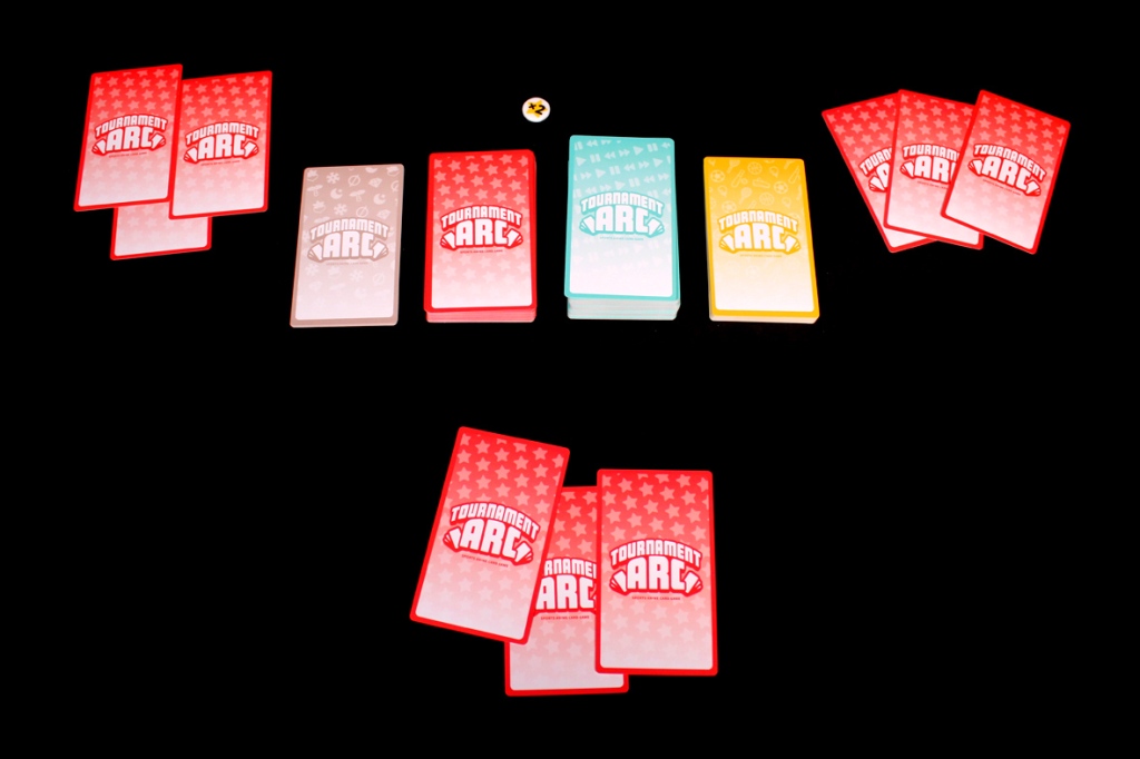 A collection of brightly colored game cards from the Tournament Arc card game, displayed on a black background. The cards feature various designs and colors, including red, yellow, and blue.